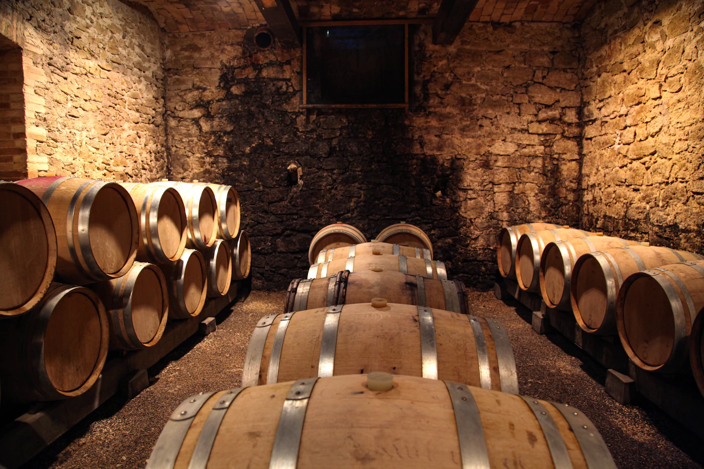 Bottles resting in a candle-lit cellar