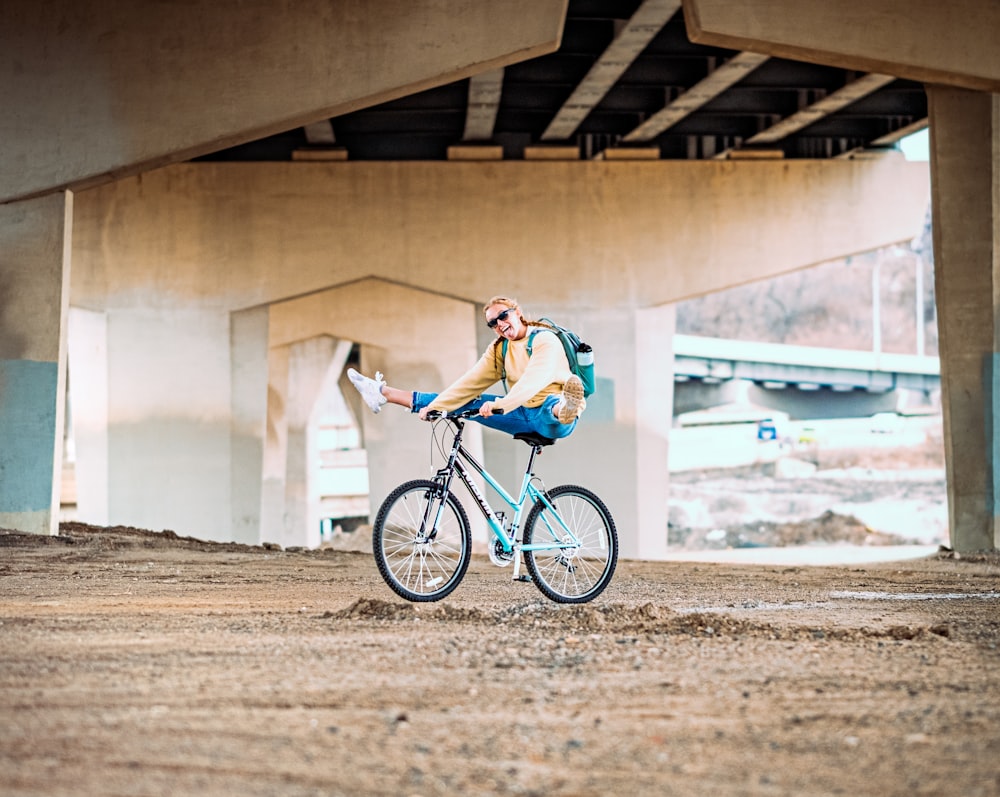 man in blue and white shirt riding on black bicycle during daytime