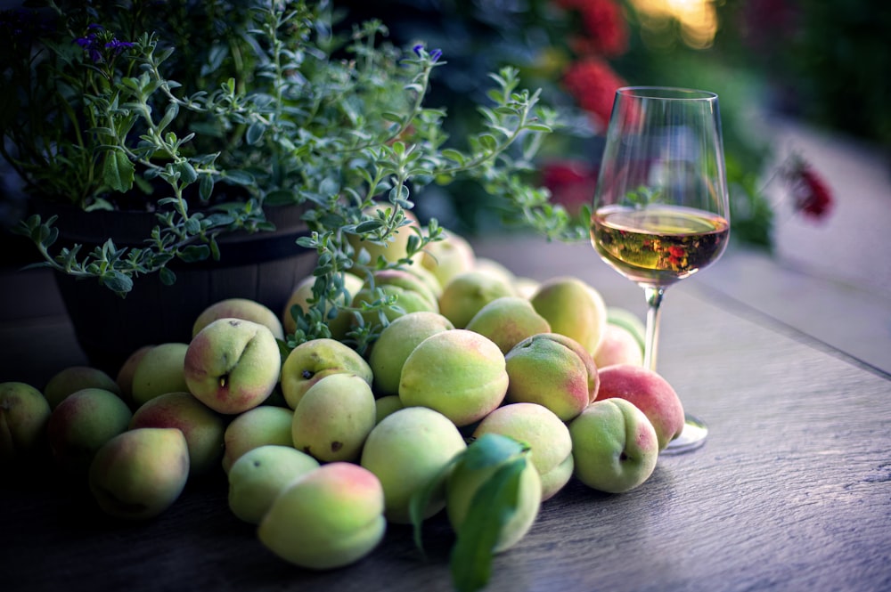 green apple fruit beside clear wine glass