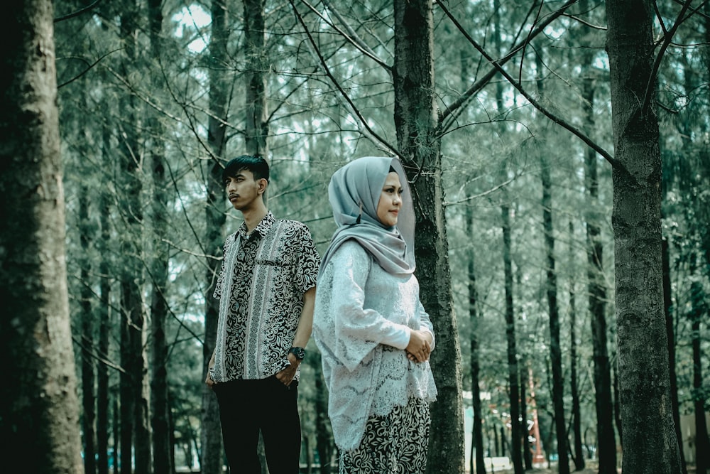 2 women in hijab standing in forest during daytime