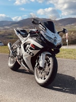 A sleek motorcycle parked on a scenic mountain road.