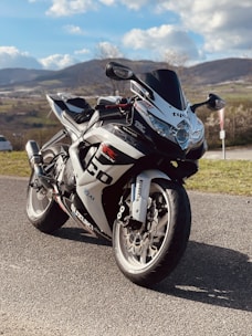 A vibrant motorcycle on a scenic road, showcasing its performance.