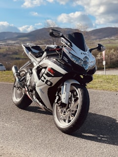 A sleek motorcycle parked on a scenic mountain road.