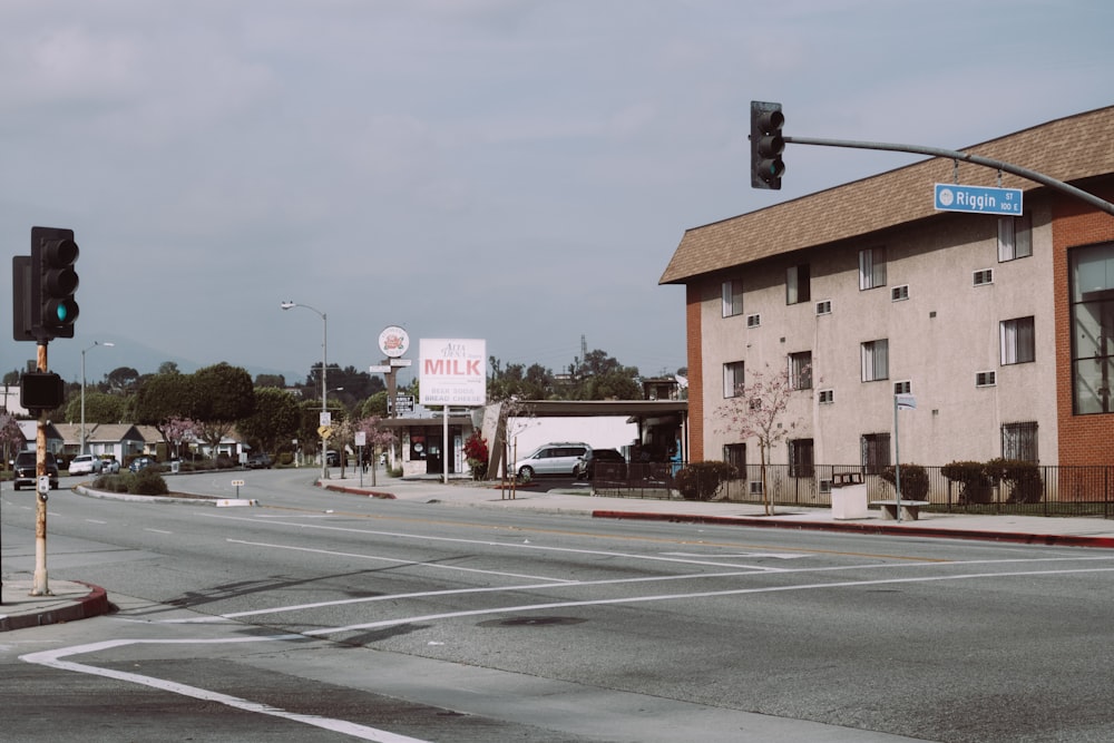 cars parked on side of the road near buildings during daytime