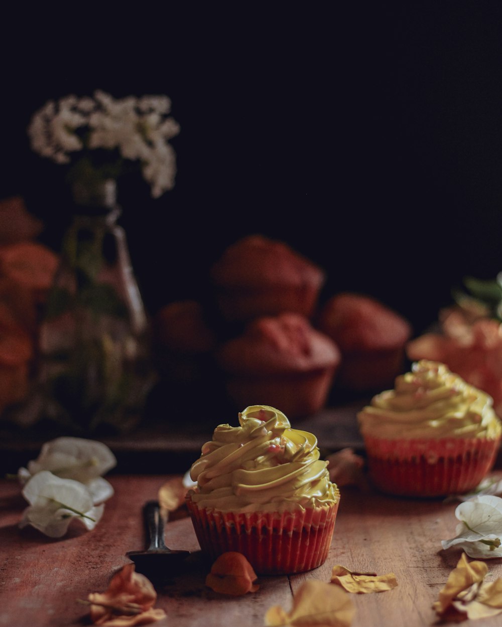 pink cupcake on brown wooden table