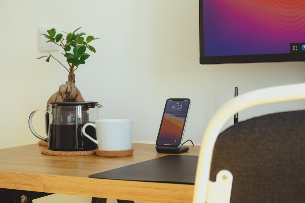 black iphone 5 on brown wooden table