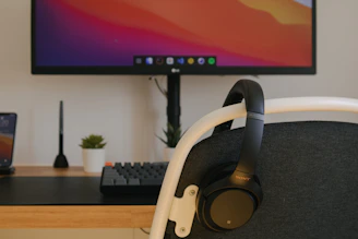 A clean, modern workspace with headset and computer ready for remote support work.