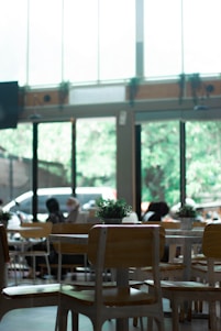 Bright, airy cafe interior with families enjoying colorful vegetarian dishes around wooden tables.