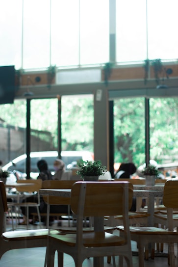 Bright, airy cafe interior with families enjoying colorful vegetarian dishes around wooden tables.