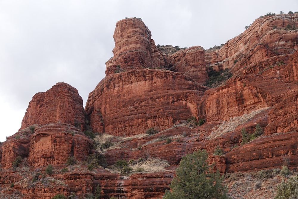 brown rock formation under white clouds during daytime