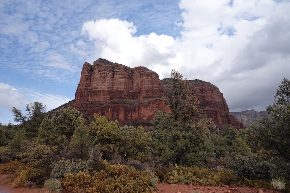brown rock formation under white clouds during daytime