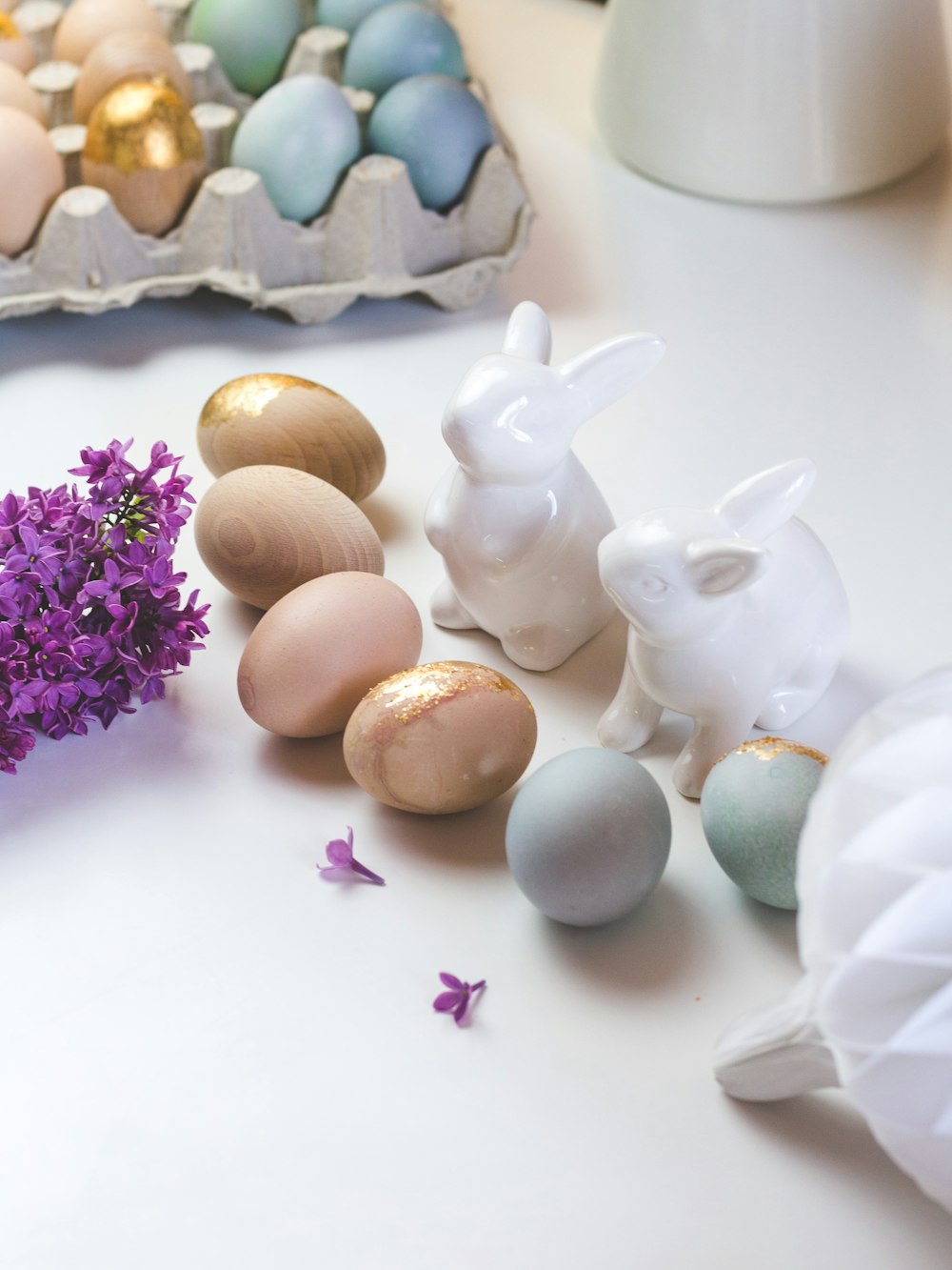 white rabbit figurine beside brown egg shell