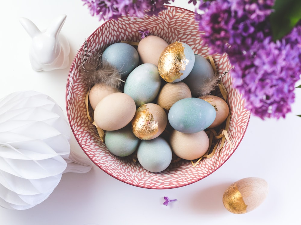 white and blue egg on brown woven basket