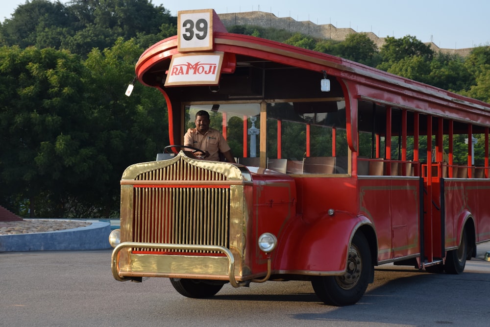 people riding red and white bus during daytime