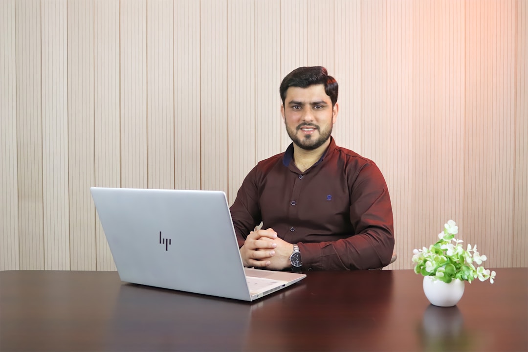 A man seated at a desk, working on a laptop, focused on an enterprise AI platform.