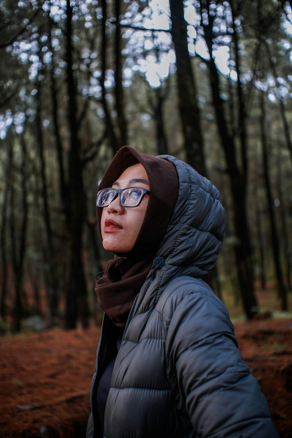 woman in black jacket wearing brown hijab