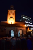 A group of Muslim travelers praying together at a beautiful mosque courtyard.