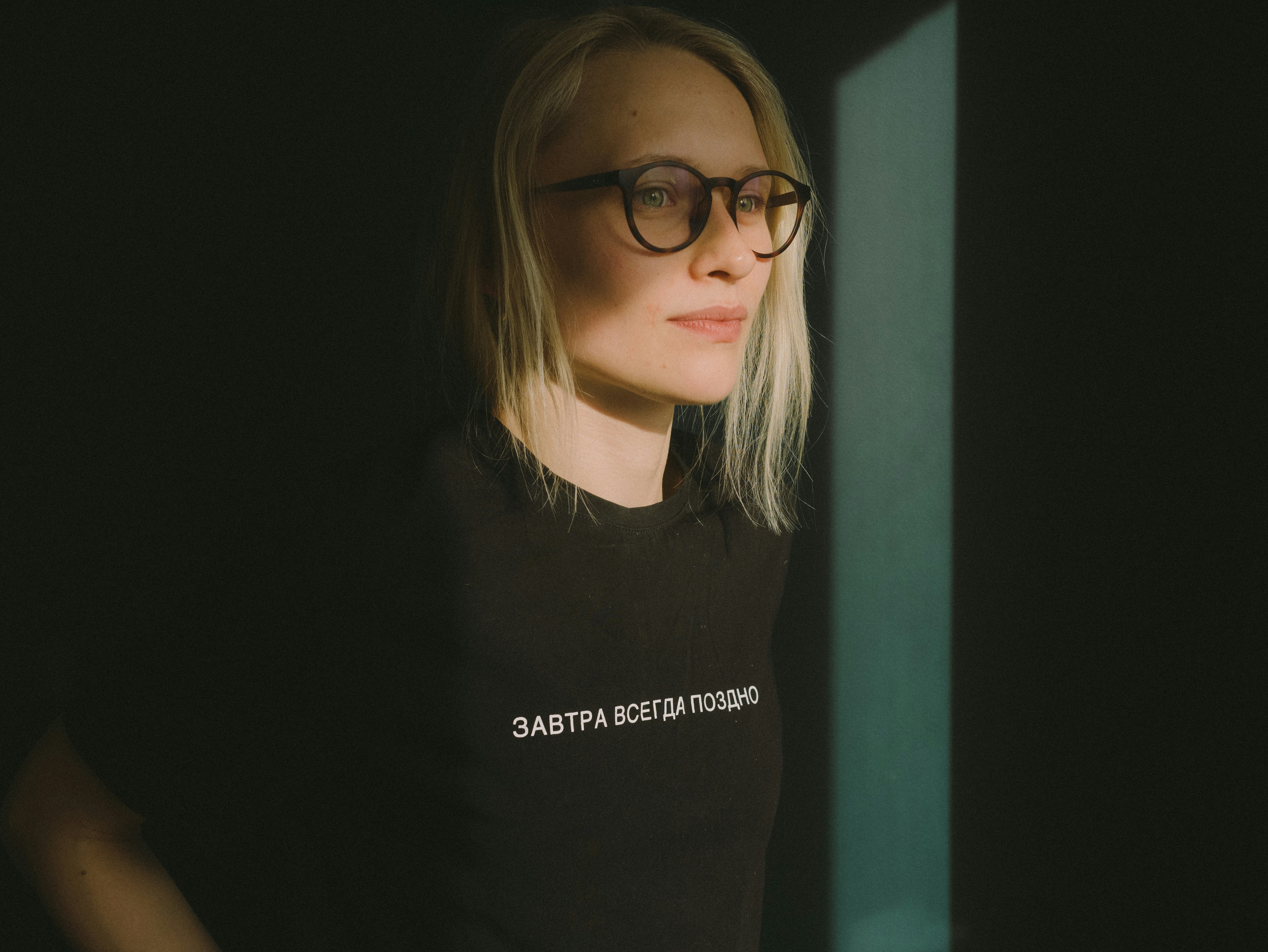 woman in black crew neck t-shirt wearing black framed eyeglasses