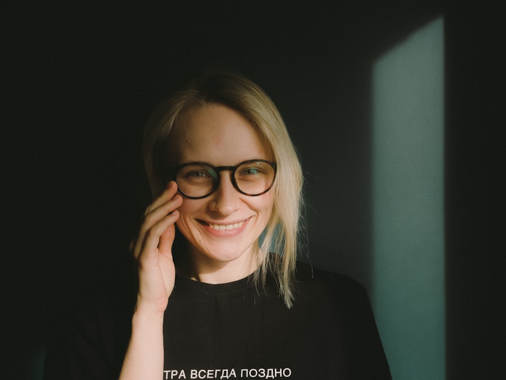 woman in black crew neck t-shirt wearing black framed eyeglasses