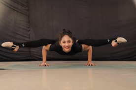 woman in black t-shirt and black pants doing yoga