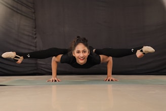 woman in black t-shirt and black pants doing yoga