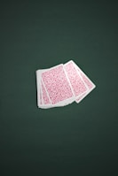 Close-up of colorful playing cards fanned out on a green felt table