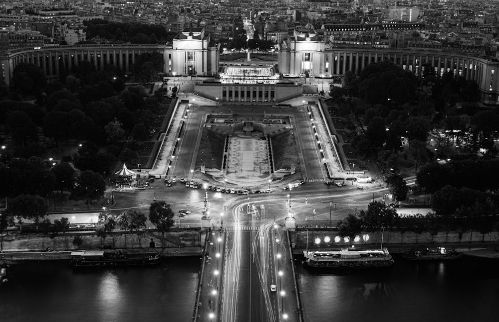 grayscale photo of city buildings and cars on road