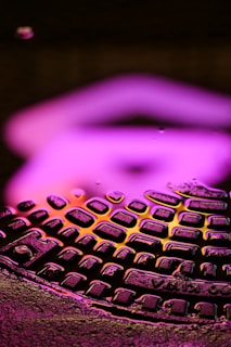 Close-up of high GSM fabric texture illuminated by neon pink and blue lights.
