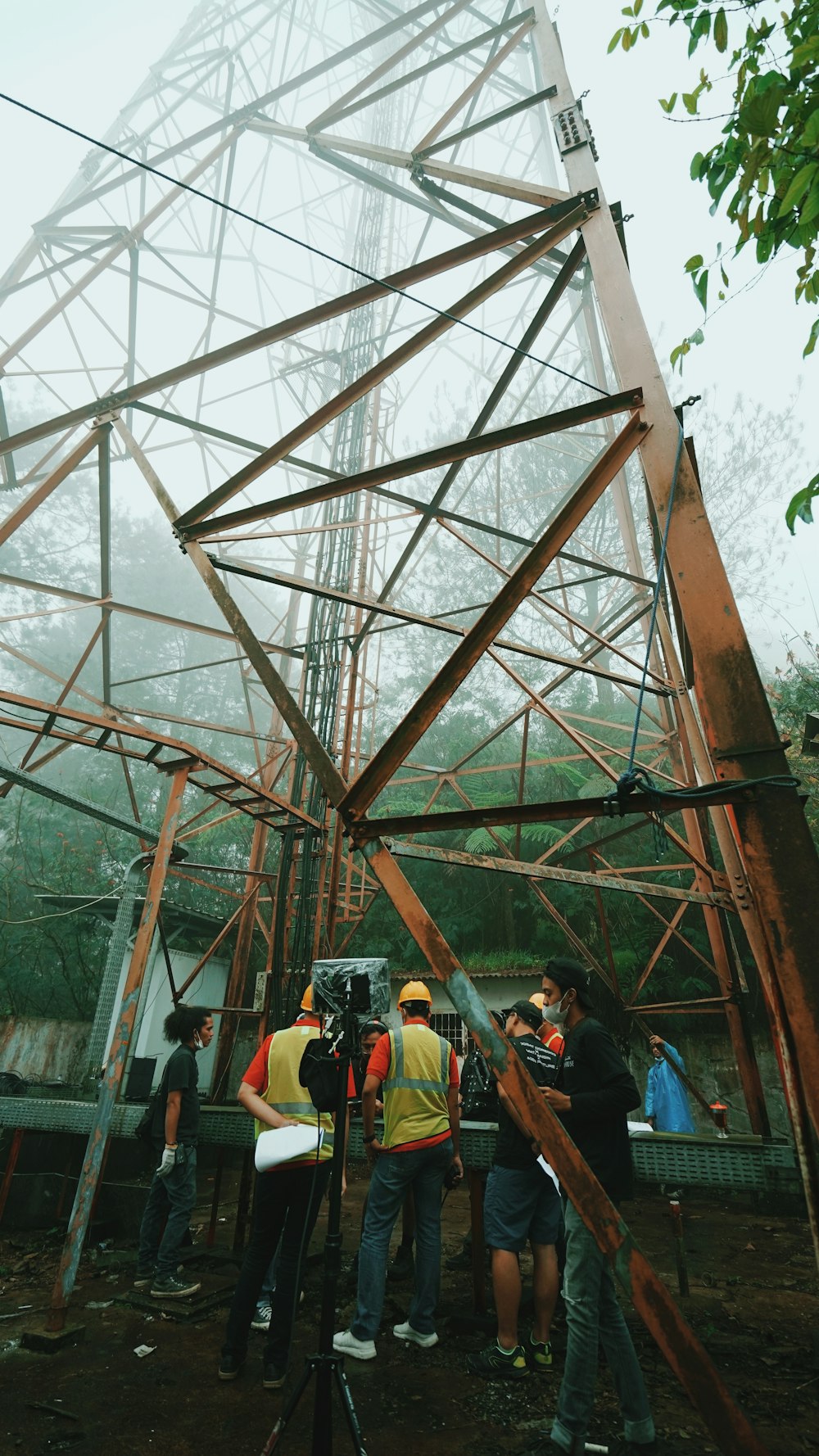 people standing under brown metal roof during daytime