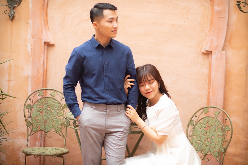 man in blue dress shirt standing beside woman in white dress shirt