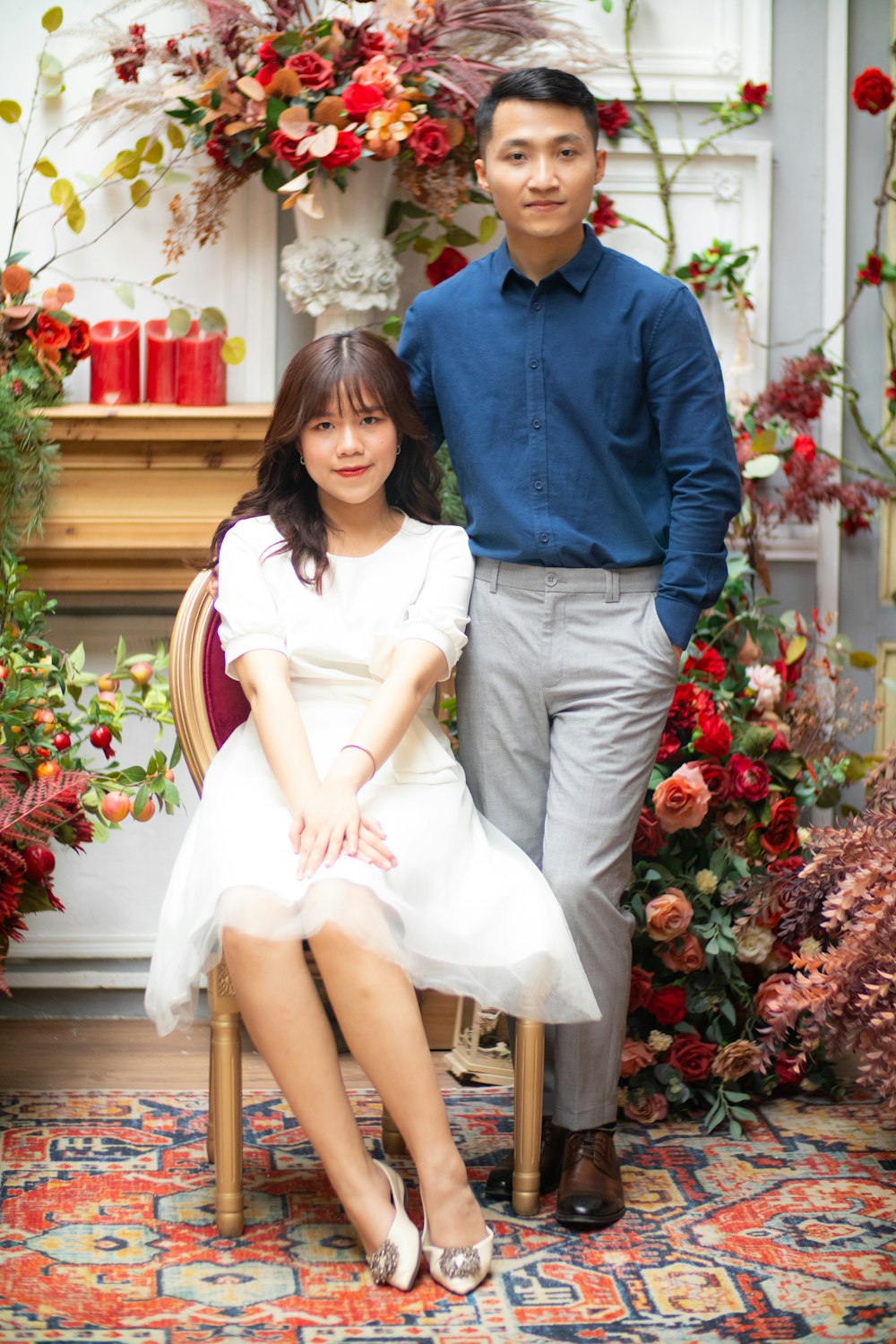 man in blue dress shirt sitting beside woman in white dress