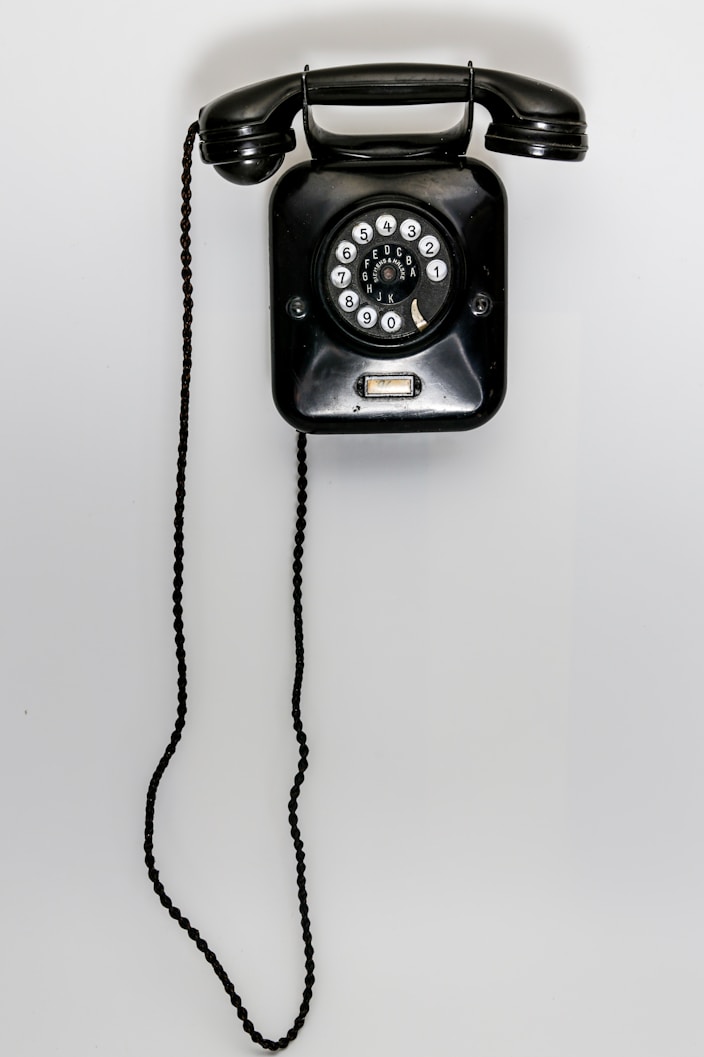 black and gray corded telephone