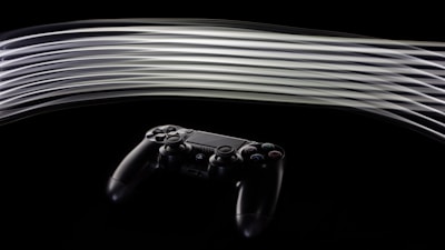 Modern gaming controller with subtle motion blur on a dark background.