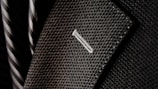 A close-up of luxurious fabric swatches for suits.