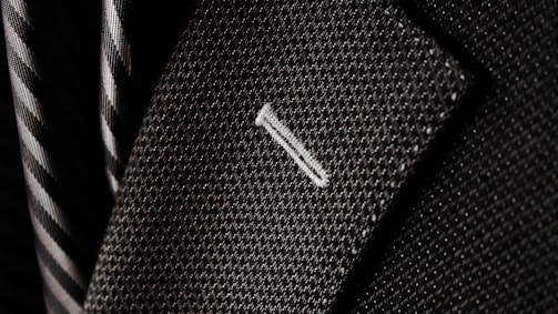 A close-up of luxurious fabric swatches for suits.