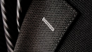 Close-up of a stylish suit jacket and tie perfect for graduation ceremonies.
