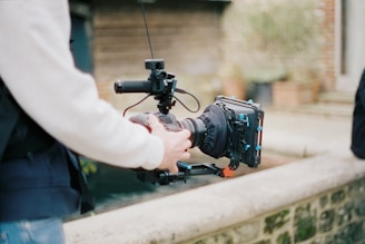 person holding black dslr camera