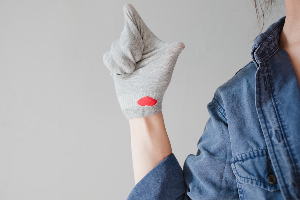 person in blue denim jeans and white socks