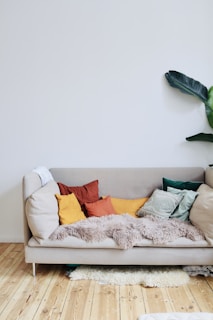 orange throw pillows on white couch