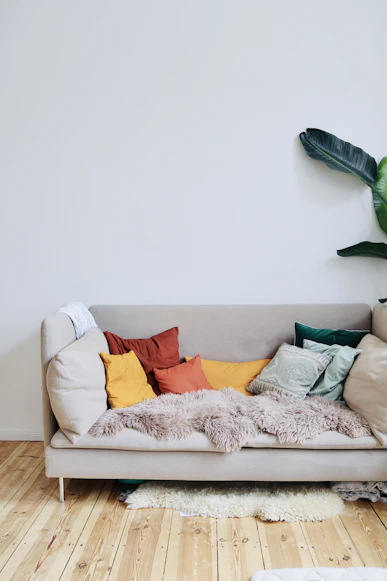 Beige Sofa with Throw Pillows in Warm Lit Cozy Living Room