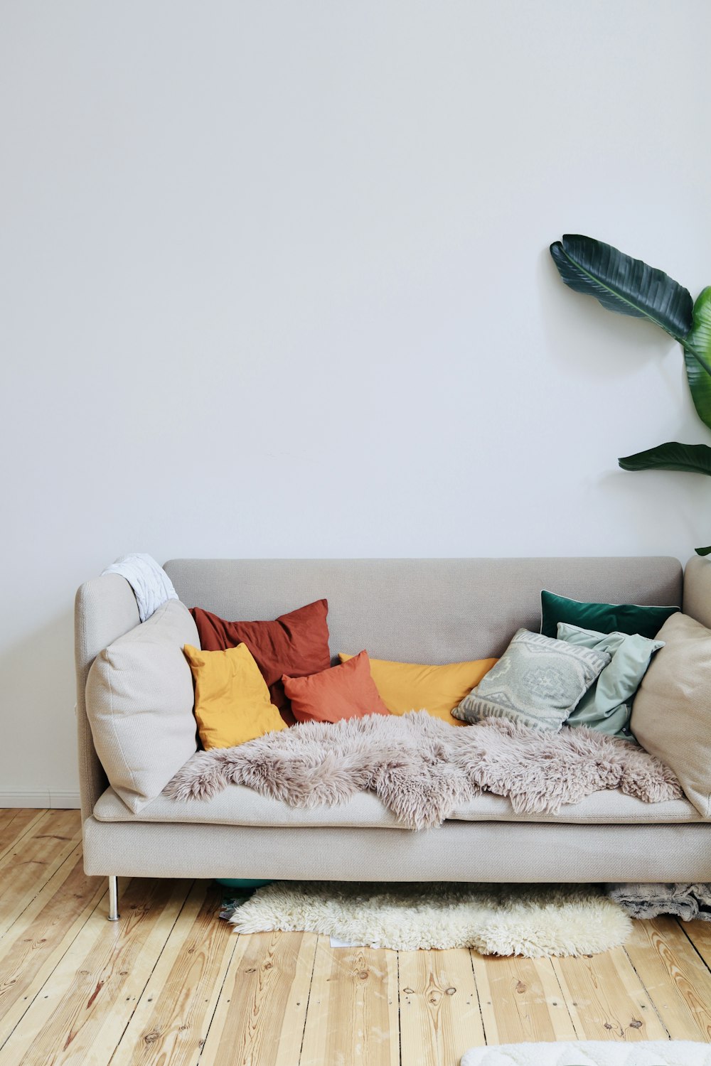 orange throw pillows on white couch