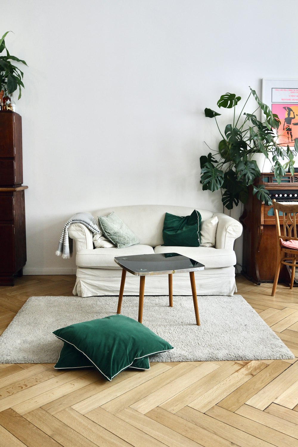 green throw pillow on white sofa