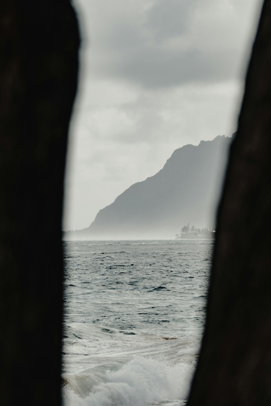 body of water near mountain during daytime