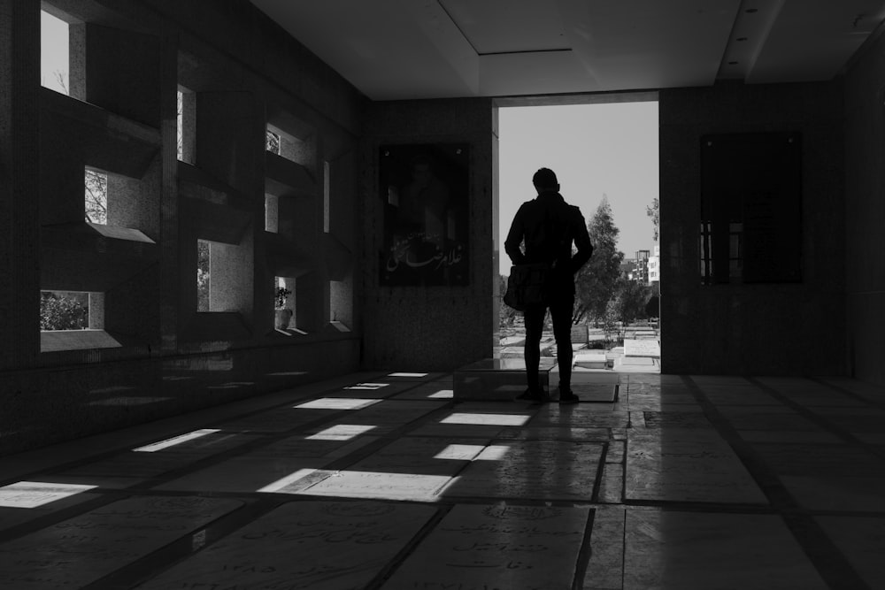 man in black jacket standing in the hallway