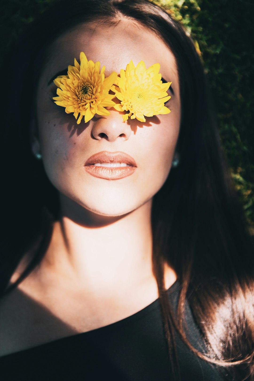 woman with yellow flower on her face
