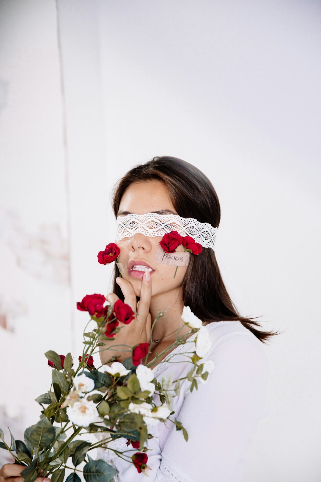 woman in white floral dress wearing white and red floral headdress