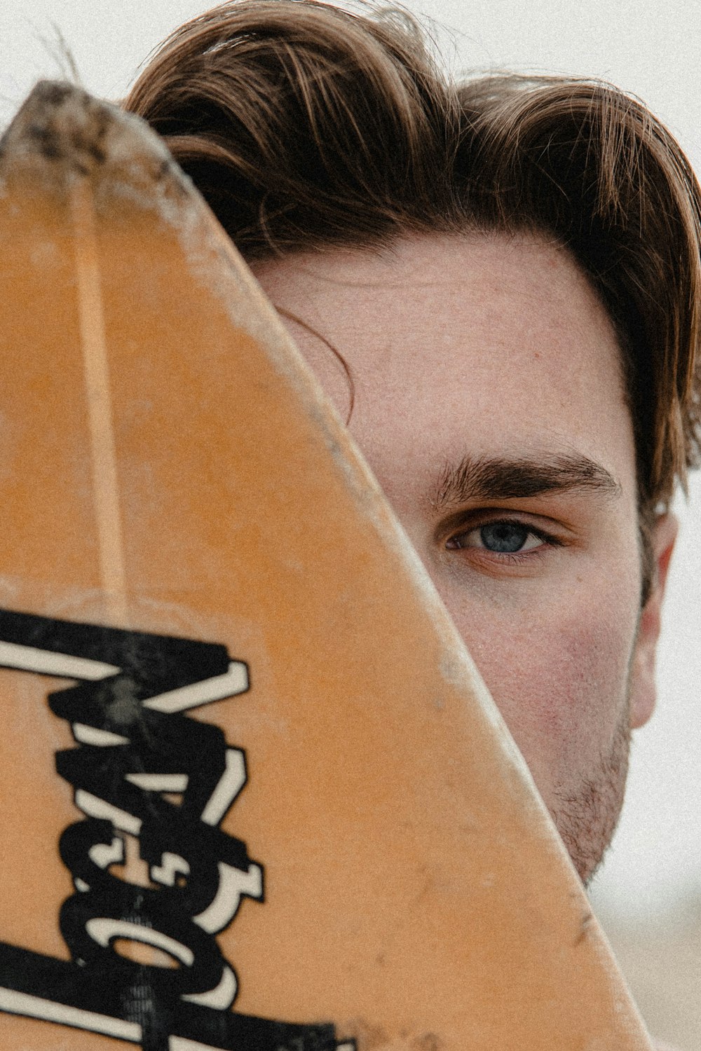 mans face on brown and white textile