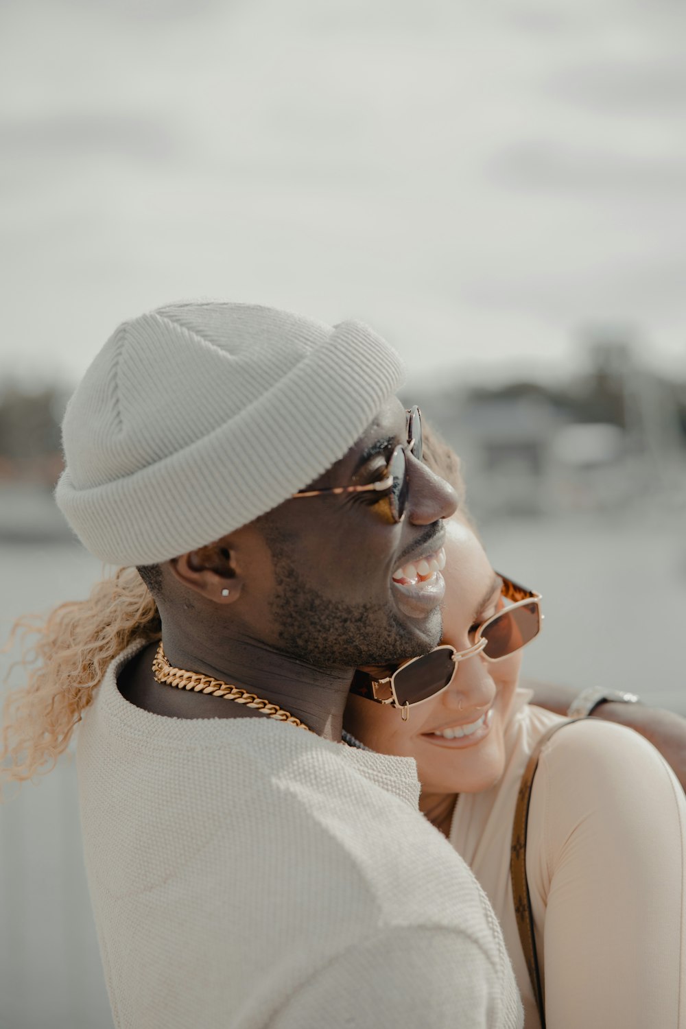 woman in white tank top wearing white knit cap and sunglasses