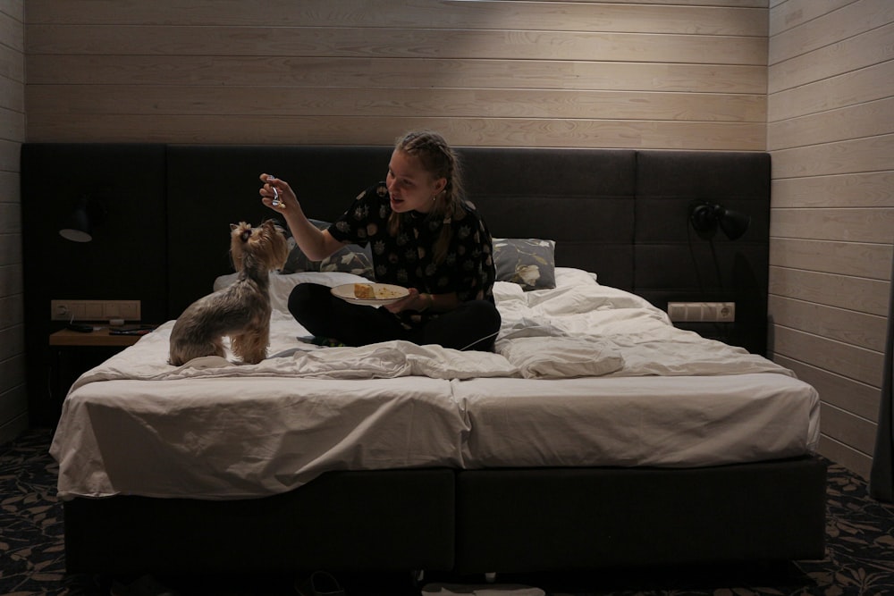 woman in black and white floral long sleeve shirt sitting on bed