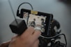 Close-up of firefighter hands entering shift data on a smartphone.